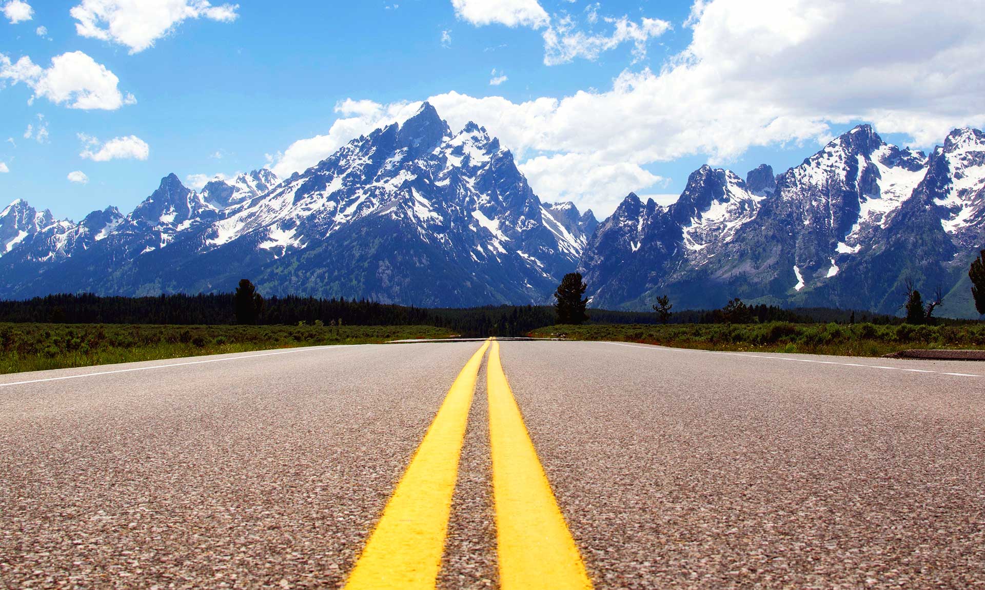 Long Road Headed Towards Snowy Mountains